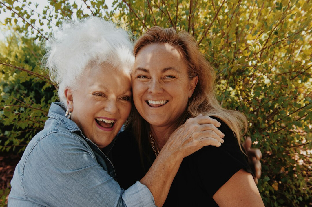 Adult daughter talking warmly with her senior mother