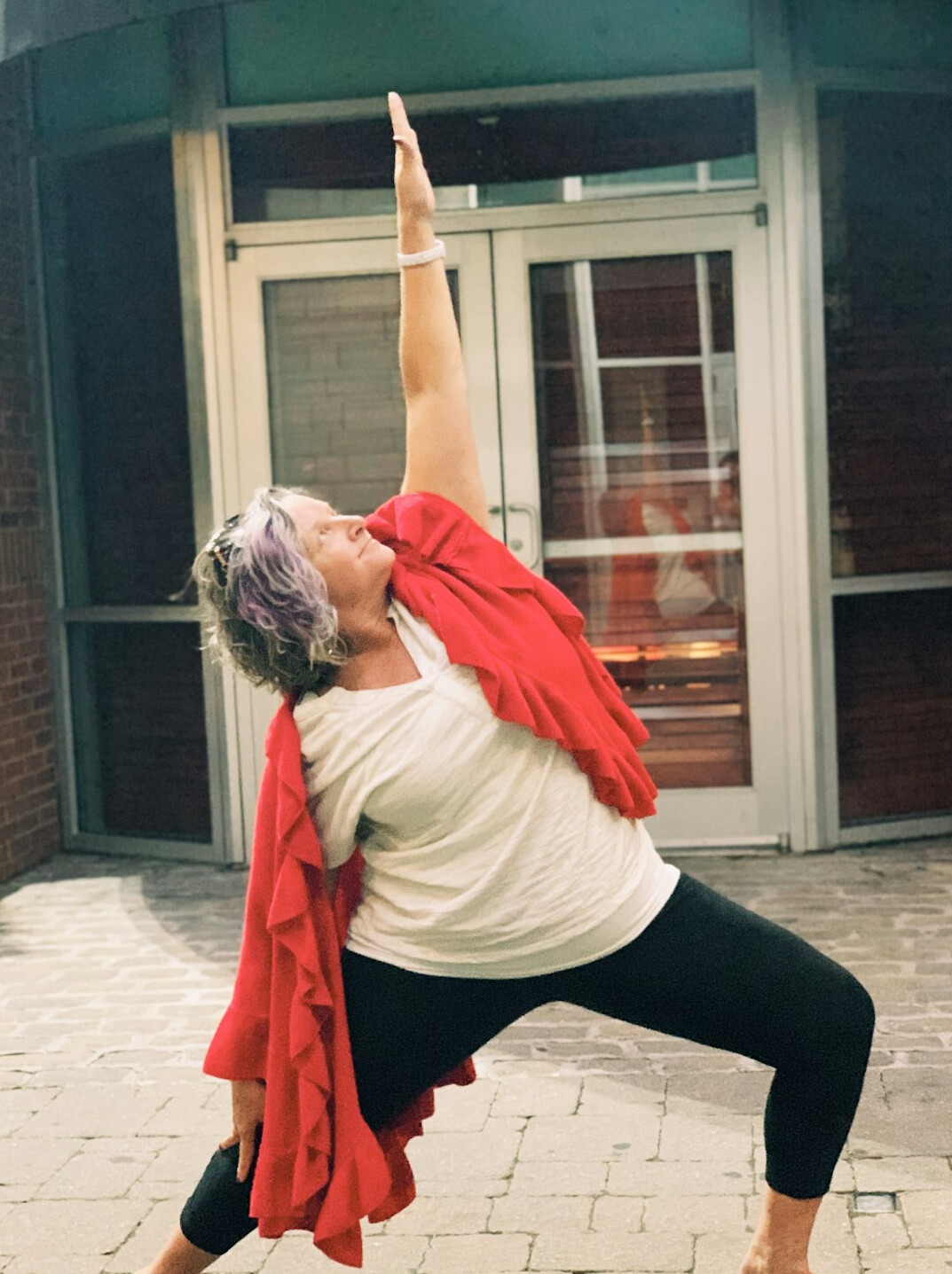 senior doing yoga outdoors
